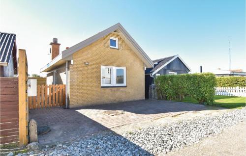 a brick house with a fence and a driveway at One-Bedroom Holiday Home In Otterup in Otterup