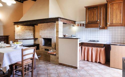 a kitchen with a table and a stove top oven at Antica Grancia Di Quercecchio in Montalcino