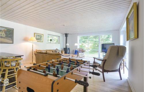 a living room with a foosball game on a table at 2 Bedroom Cozy Home In Ebeltoft in Øksenmølle