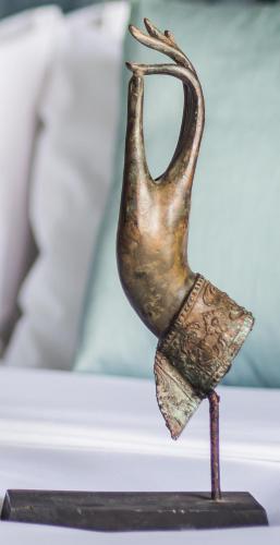 a bronze vase sitting on top of a table at Siem Reap Palace Hotel & Spa in Siem Reap