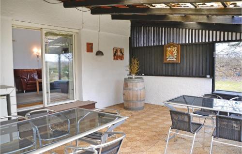 a room with a table and chairs and a barrel at Holiday Home Ellevej in Karlstrup Strand