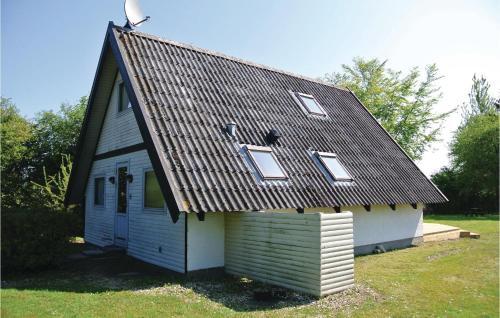 a small house with a roof on top of it at Holiday Home Brombærvænget Humble Vi in Humble