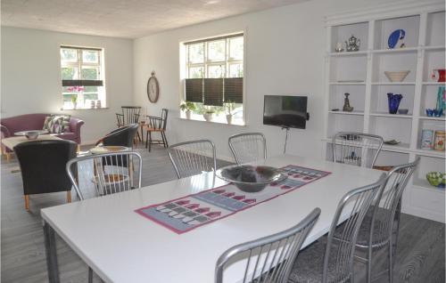 a dining room with a white table and chairs at Holiday Home Outrup I in Vester Debel
