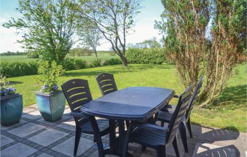 a blue table and chairs on a patio at Holiday Home Outrup I in Vester Debel