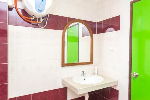 a bathroom with a sink and a mirror at Kita Hotel in Tanjung Pinang 