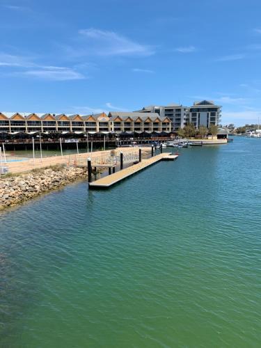 a dock in the middle of a body of water at The Hutt on Mandurah Marina in Mandurah