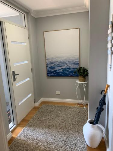 a hallway with a door and a window at The Hutt on Mandurah Marina in Mandurah