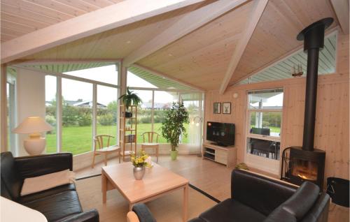 a living room with a fireplace and a table at Holiday Home Elsdyrstien Ca Dnmk in Marielyst