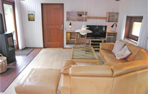 a living room with a couch and a television at Holiday Home Nexø 14 in Vester Sømarken
