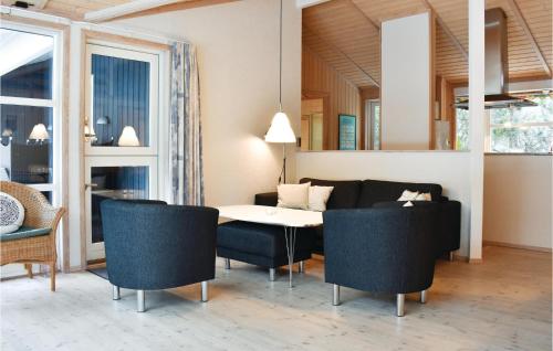 a living room with a table and chairs at Holiday Home Krondyrstien Væggerløse Denm in Marielyst