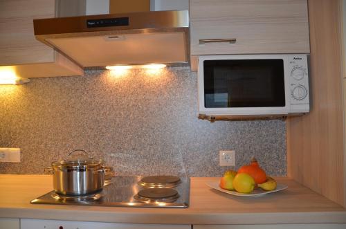 a kitchen with a microwave and a bowl of fruit at Ferienwohnung Garber in Uderns
