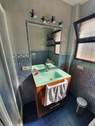 a bathroom with a sink and a mirror at Villa Solojog23 in Arriate