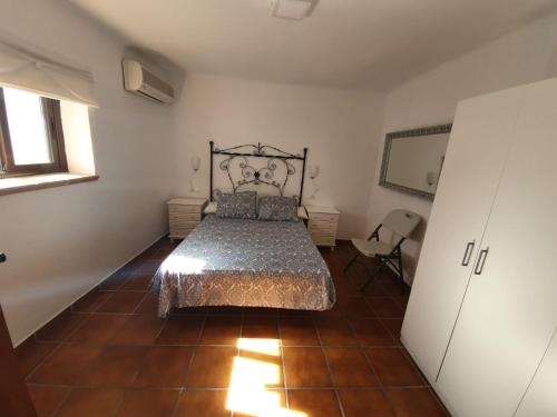 a bedroom with a bed and a chair in it at Villa Solojog23 in Arriate