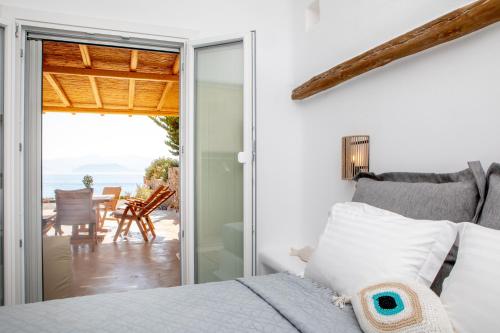 a bedroom with a bed and a view of the ocean at VILLA AGAPITOS in Naxos Chora