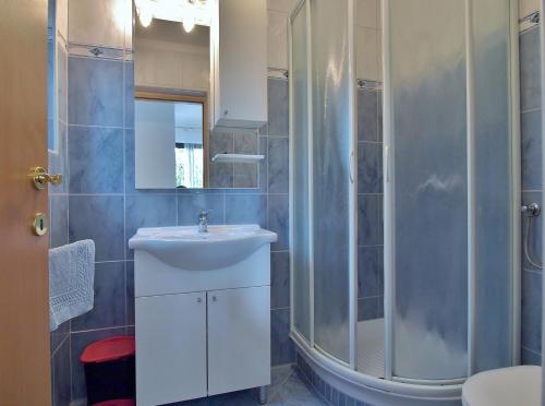 a bathroom with a sink and a shower at Apartments Eufemija in Rab