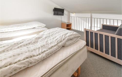 ファーボにあるAmazing Apartment In Faaborg With 2 Bedrooms, Wifi And Outdoor Swimming Poolのベッドルーム1室(ベッド2台、椅子付)