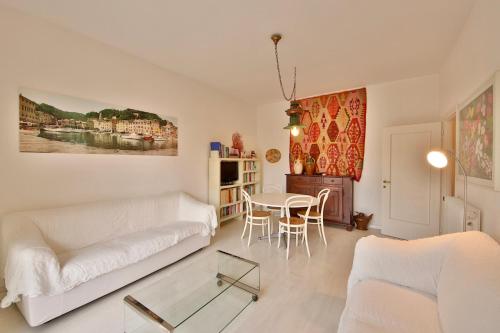 a living room with a white couch and a table at Sofia by KlabHouse in Santa Margherita Ligure