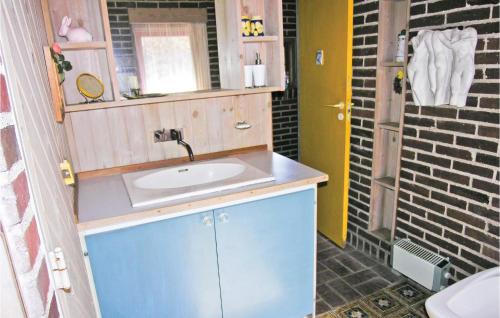 a bathroom with a sink and a mirror at Holiday Home Harevænget in Asperup