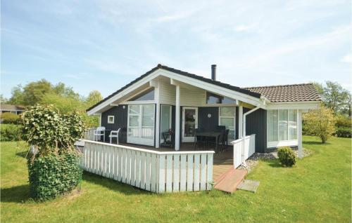 a small house with a porch and a deck at Holiday Home Elsdyrstien Ca Dnmk in Marielyst