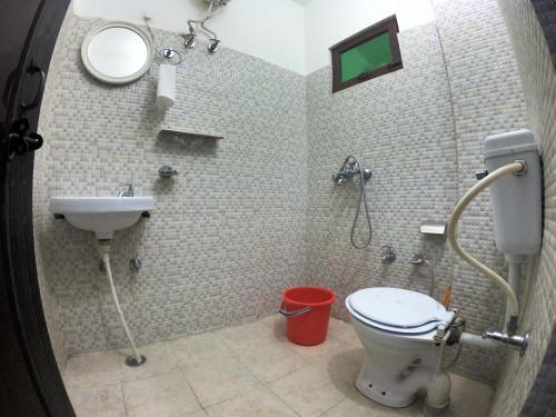 a bathroom with a toilet and a sink at Soul Haven in Rishīkesh