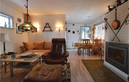 a living room with a couch and a fireplace at Three-Bedroom Holiday Home In Vig in Vig