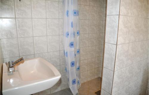 a shower curtain next to a sink in a bathroom at Awesome Apartment In Nrre Nebel With 1 Bedrooms And Wifi in Stavsø