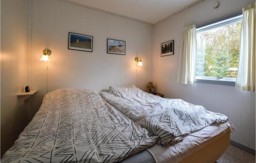 a bedroom with a bed with a comforter and a window at Beautiful Home In Vig With 3 Bedrooms And Wifi in Vig