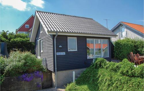 a small house with a gray roof at One-Bedroom Holiday Home In Sjolund in Sjølund