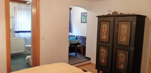 a bedroom with a mirror and a bathroom with a toilet at Pension Wassererhof in Gerlos