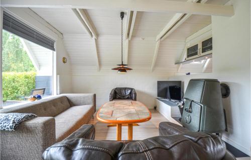 a living room with a couch and a table at Holiday Home Ebeltoft - 05 in Ebeltoft