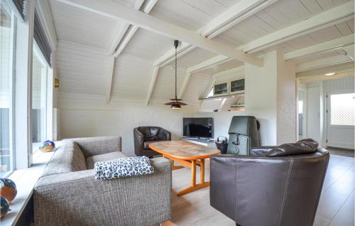 a living room with a couch and a table at Holiday Home Ebeltoft - 05 in Ebeltoft