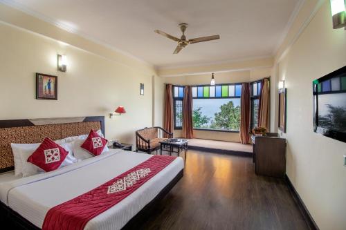 a hotel room with a bed and a window at Snow Valley Resorts Dalhousie in Dalhousie