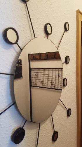 a mirror hanging on a wall with a guitar at Ferien-& Monteurwohnung Koenen2 nah am Westfield Centro in Oberhausen