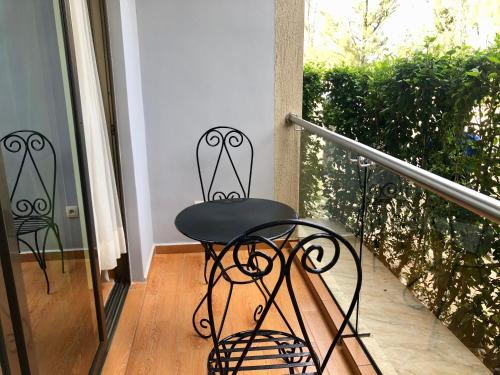 a black chair sitting on a porch at Heaven Restaurant & Boutique Hotel in Kigali