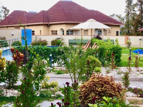 a house with a garden in front of it at Heaven Restaurant & Boutique Hotel in Kigali