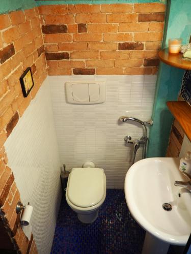 a bathroom with a white toilet and a sink at Casa di Pierina in Poggibonsi