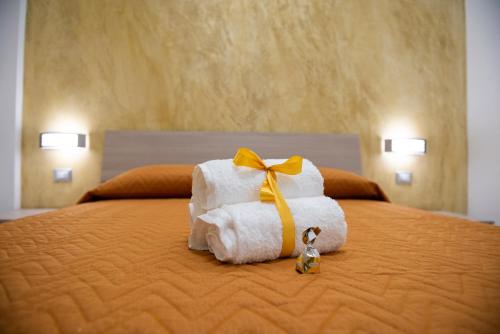 stos ręczników na łóżku w obiekcie Stabia Dream Rooms w mieście Castellammare di Stabia