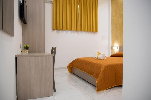 a bedroom with a bed and a yellow curtain at Stabia Dream Rooms in Castellammare di Stabia