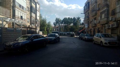 a group of cars parked on a city street at Yair room apartment in Jerusalem