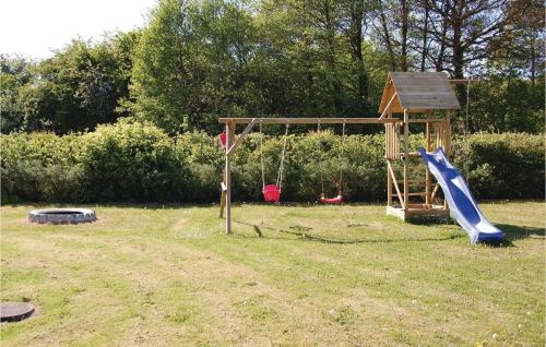 a playground with a slide and a swing at Holiday Home Hvedemarken Sjølund I in Sjølund