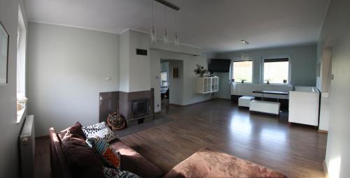 a living room with a couch and a fireplace at SIELANKA in Stronie Śląskie