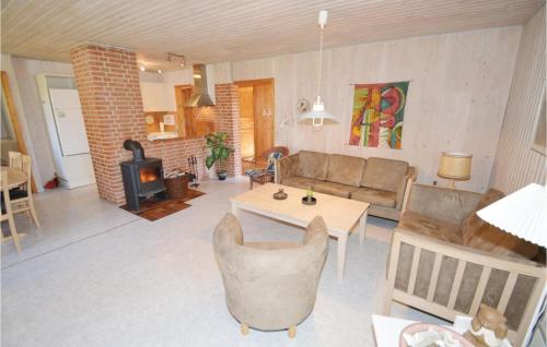 sala de estar con sofá, mesa y chimenea en Nice Home In Lgstr With Kitchen, en Trend