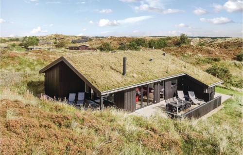 a house with a grass roof on top of a hill at Three-Bedroom Holiday Home In Henne in Henne Strand