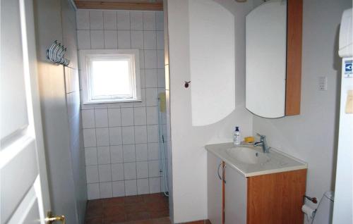 a small bathroom with a sink and a shower at Amazing Home In Lgstr With 2 Bedrooms in Løgstør