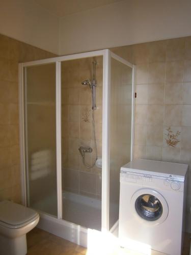 a bathroom with a shower and a washing machine at CASA IN RIVA AL LAGO in Varenna