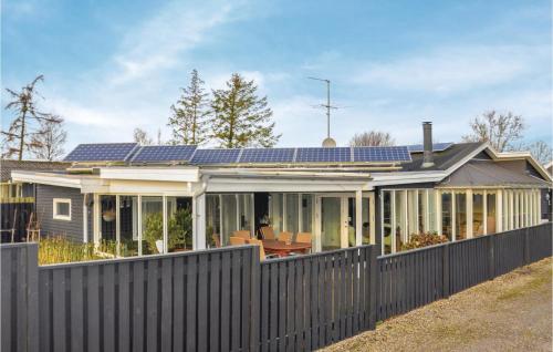 a house with solar panels on the roof at Five-Bedroom Holiday Home In Otterup in Otterup