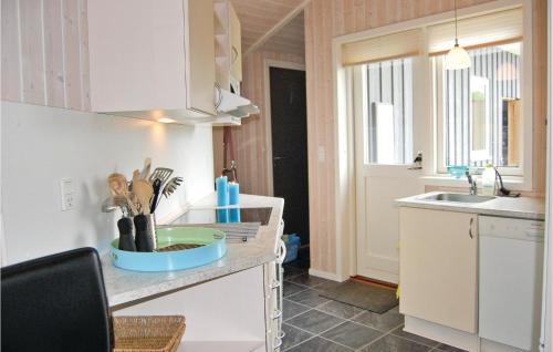 a kitchen with a sink and a counter top at Stunning Home In Juelsminde With Sauna, Wifi And 3 Bedrooms in Sønderby