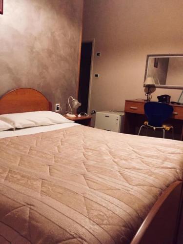 Una cama o camas en una habitación de B&B Locanda La Rotonda