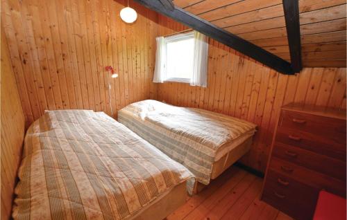 a bedroom with two beds in a wooden cabin at Gorgeous Home In Sydals With Wifi in Skovbyballe