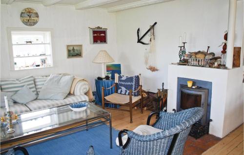 a living room with a couch and a fireplace at Rosenhavet in Vejby